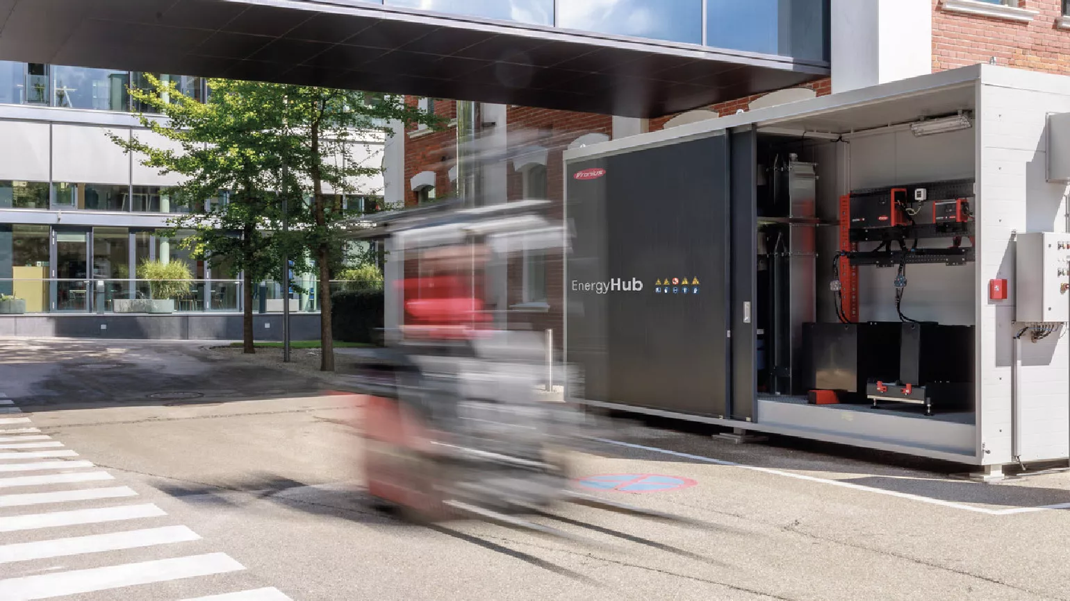 Fronius EnergyHub und EnergyCase vor einem Backsteingebäude.