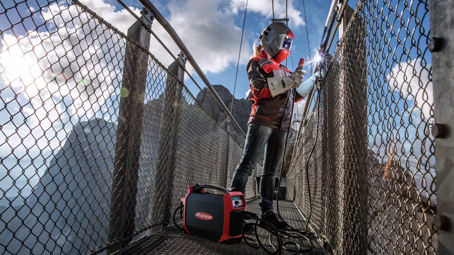 Woman is welding outdoors