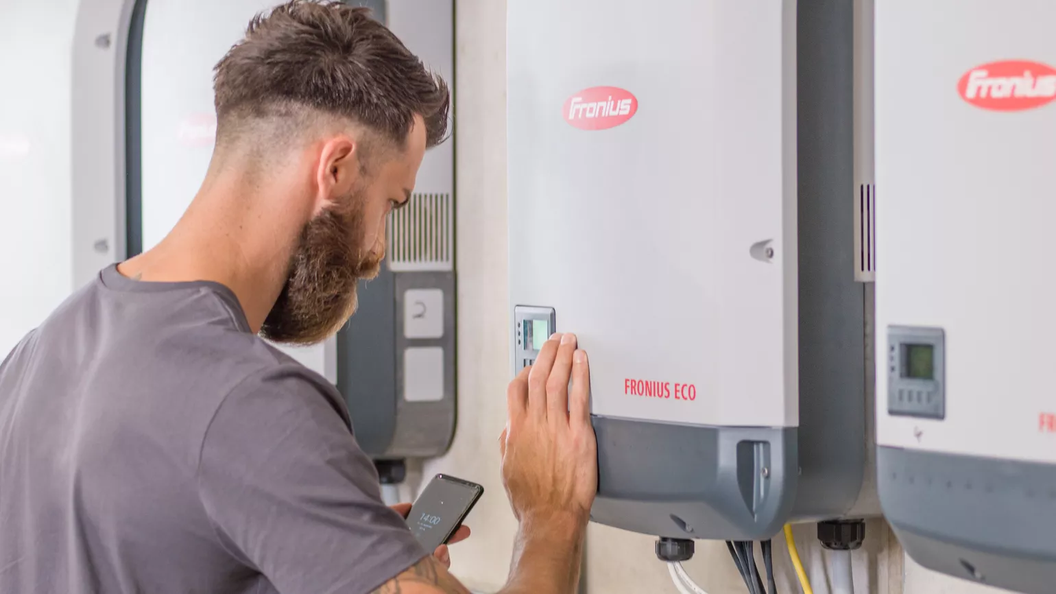 Installer changing inverter settings with smartphone