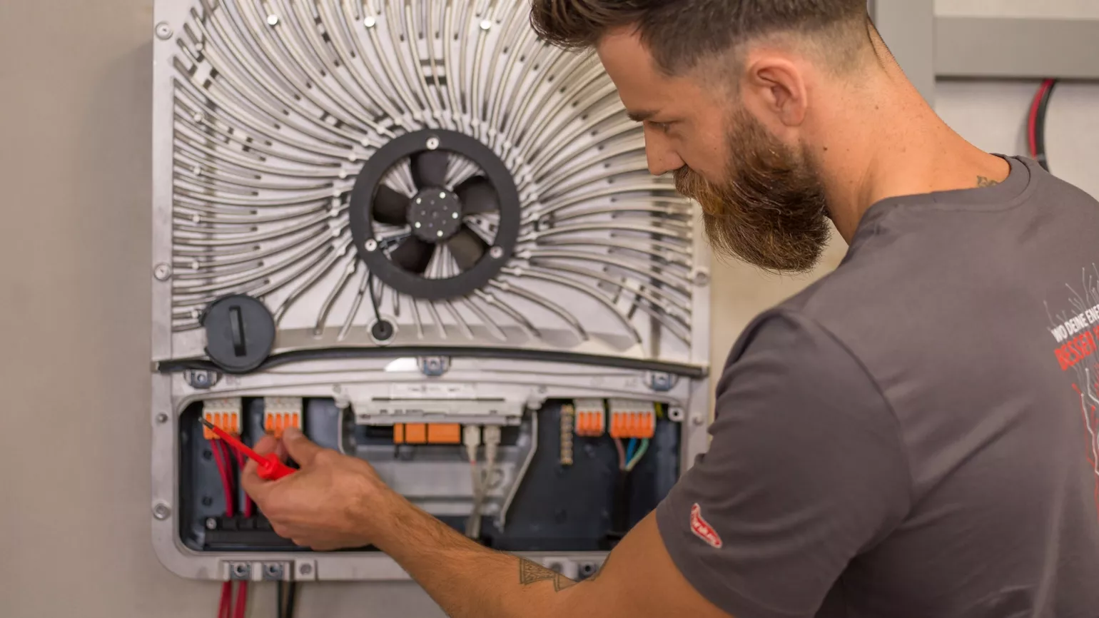 Installer in front of open GEN24 inverter